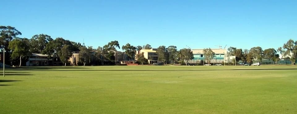 Trinity College buildings across the oval in East Perth